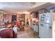 An outdated kitchen with white appliances, tile flooring, and lots of clutter throughout at 10854 Telford St, New Port Richey, FL 34654