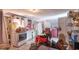 An outdated kitchen with white appliances, tile flooring, and lots of clutter throughout at 10854 Telford St, New Port Richey, FL 34654