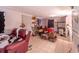 A cluttered living room featuring a red couch, tile flooring, and minimal lighting at 10854 Telford St, New Port Richey, FL 34654