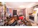 A cluttered living room featuring various household goods, boxes, and minimal lighting at 10854 Telford St, New Port Richey, FL 34654