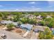 Aerial view of the house, neighborhood and surrounding area with beautiful trees at 10900 Queens Rd, Port Richey, FL 34668