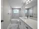 Updated bathroom featuring shower over tub, modern fixtures and bright lighting at 10900 Queens Rd, Port Richey, FL 34668