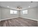 Bright bedroom featuring updated flooring and lots of natural light from windows at 10900 Queens Rd, Port Richey, FL 34668