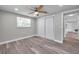 Comfortable bedroom featuring updated flooring, closet and natural light at 10900 Queens Rd, Port Richey, FL 34668