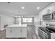 Bright, updated kitchen with island, stainless appliances and white cabinets at 10900 Queens Rd, Port Richey, FL 34668