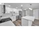 Modern kitchen with stainless steel appliances, sleek white cabinetry, and an open design at 10900 Queens Rd, Port Richey, FL 34668