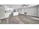 Open-concept living space with modern flooring, ceiling fan, and seamlessly connecting to the updated kitchen at 10900 Queens Rd, Port Richey, FL 34668