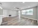 Bright living area features fresh paint, modern floors, a ceiling fan, and ample natural light from large windows at 10900 Queens Rd, Port Richey, FL 34668