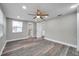 Spacious main bedroom featuring updated flooring and an ensuite bathroom at 10900 Queens Rd, Port Richey, FL 34668