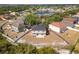 Aerial view of the home showcasing its backyard, surrounding neighborhood, and proximity to a pond at 10930 Banyan Wood Way, Riverview, FL 33579