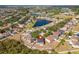 Aerial view of home in a lakeside neighborhood, with a spacious lot and attractive landscaping at 10930 Banyan Wood Way, Riverview, FL 33579