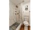 Modern bathroom with a beautiful shower, with marble tile, gold fixtures, and decorative black and white tiled floor at 10930 Banyan Wood Way, Riverview, FL 33579