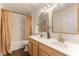 This bathroom features a double sink vanity, wood-look floors, and a bathtub with shower at 10930 Banyan Wood Way, Riverview, FL 33579