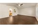 Large bedroom features an adjoining bathroom, natural light, neutral walls, and wood-look floors for a serene ambiance at 10930 Banyan Wood Way, Riverview, FL 33579