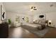 Stylish bedroom showcasing a comfortable bed, modern decor, wood-look floors, and natural light, creating a tranquil space at 10930 Banyan Wood Way, Riverview, FL 33579