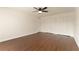 This bedroom features wood-look floors, a ceiling fan, and a double door closet at 10930 Banyan Wood Way, Riverview, FL 33579