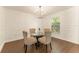 Dining area featuring modern lighting fixture, wood flooring, and decorative wall trim at 10930 Banyan Wood Way, Riverview, FL 33579