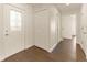 Bright entryway featuring hardwood floors, closet, and a front door with decorative glass at 10930 Banyan Wood Way, Riverview, FL 33579