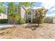 Two-story home features lush landscaping, a palm tree, and a modern exterior at 10930 Banyan Wood Way, Riverview, FL 33579
