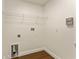 Bright laundry room with wooden floor, wire shelf, and utility connections, ready for appliances and storage at 10930 Banyan Wood Way, Riverview, FL 33579