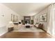 Living room with modern fireplace, wood-look floors, neutral walls, curated furniture, and decorative wall art at 10930 Banyan Wood Way, Riverview, FL 33579