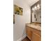 This powder room includes wood-look floors, attractive fixtures, and a decorative mirror at 10930 Banyan Wood Way, Riverview, FL 33579