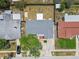 Birds eye view of single-story home with zero-scape front yard, mature tree and stone facade garage at 1150 Grand Blvd, Holiday, FL 34690
