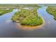 Aerial view of a scenic island showcasing natural vegetation and surrounded by water in a secluded area at 1150 Grand Blvd, Holiday, FL 34690