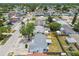 Aerial view showing a single-Gathering home near a road, with a fenced backyard, and a large mature tree at 1150 Grand Blvd, Holiday, FL 34690