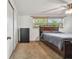 Bedroom with carpeted floors, natural light from a large window, and a ceiling fan at 1150 Grand Blvd, Holiday, FL 34690