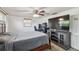 Nicely arranged bedroom with a TV stand and large screen television at 1150 Grand Blvd, Holiday, FL 34690