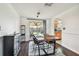 Dining room with a dark hardwood floors and a view of the backyard from the sliding glass doors at 1150 Grand Blvd, Holiday, FL 34690