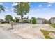 View of the house and driveway, stone accents with mature landscaping, and ample parking at 1150 Grand Blvd, Holiday, FL 34690