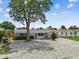 Charming single-story home featuring a stone facade garage and well-maintained, zero-scape front yard at 1150 Grand Blvd, Holiday, FL 34690