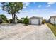 View of the house and driveway, stone accents with mature landscaping, and ample parking at 1150 Grand Blvd, Holiday, FL 34690