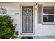 Inviting front entrance with decorative door, landscaping, and charming details at 1150 Grand Blvd, Holiday, FL 34690