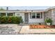 Inviting front entrance with decorative door, landscaping, and charming details at 1150 Grand Blvd, Holiday, FL 34690