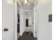 Hallway with hardwood floors, access to multiple rooms, and overhead lighting at 1150 Grand Blvd, Holiday, FL 34690