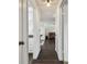 Hallway with hardwood floors, showing access to the kitchen and living room areas at 1150 Grand Blvd, Holiday, FL 34690