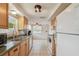 Bright kitchen featuring appliances, ample cabinet space, and tiled flooring at 1150 Grand Blvd, Holiday, FL 34690
