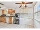 Bright kitchen with a coffee bar in the corner, and wooden cabinets and white appliances along the wall at 1150 Grand Blvd, Holiday, FL 34690