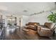 Open-concept living space with hardwood floors, kitchen access, dining area, and comfortable seating at 1150 Grand Blvd, Holiday, FL 34690