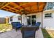 Covered patio featuring comfortable outdoor seating, accessible from sliding glass doors at 1150 Grand Blvd, Holiday, FL 34690