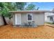Inviting backyard featuring a small patio with seating and mulch, providing a tranquil outdoor space at 116 W Chelsea St, Tampa, FL 33603