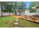Charming backyard featuring a deck with seating, mulch, and a lush green lawn, creating a relaxing outdoor space at 116 W Chelsea St, Tampa, FL 33603