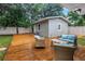 Cozy backyard with a wooden deck and stylish outdoor furniture, ideal for relaxation and enjoying the outdoors at 116 W Chelsea St, Tampa, FL 33603