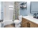 Well-lit bathroom with modern fixtures, a stylish vanity, and a shower with a floral curtain at 116 W Chelsea St, Tampa, FL 33603