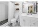 Modern bathroom with a white vanity, subway tile shower, and patterned tile floor, offering a clean aesthetic at 116 W Chelsea St, Tampa, FL 33603