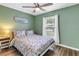 Bright bedroom with colorful bedding, ceiling fan, and natural light, offering a comfortable and inviting atmosphere at 116 W Chelsea St, Tampa, FL 33603