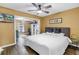 Serene bedroom with calming colors, TV, and open transition into den with natural light at 116 W Chelsea St, Tampa, FL 33603